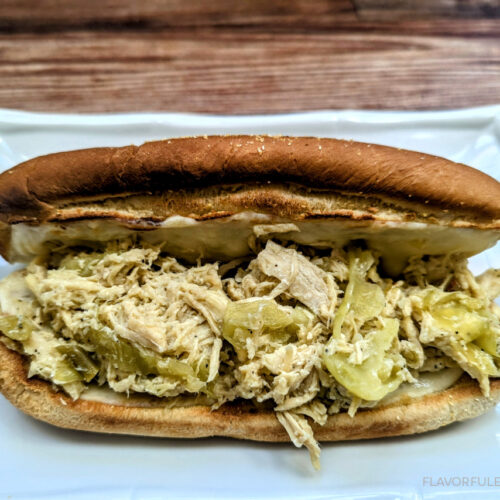 A Slow Cooker Chicken Pepperoncini Cheesesteaks on a white plate