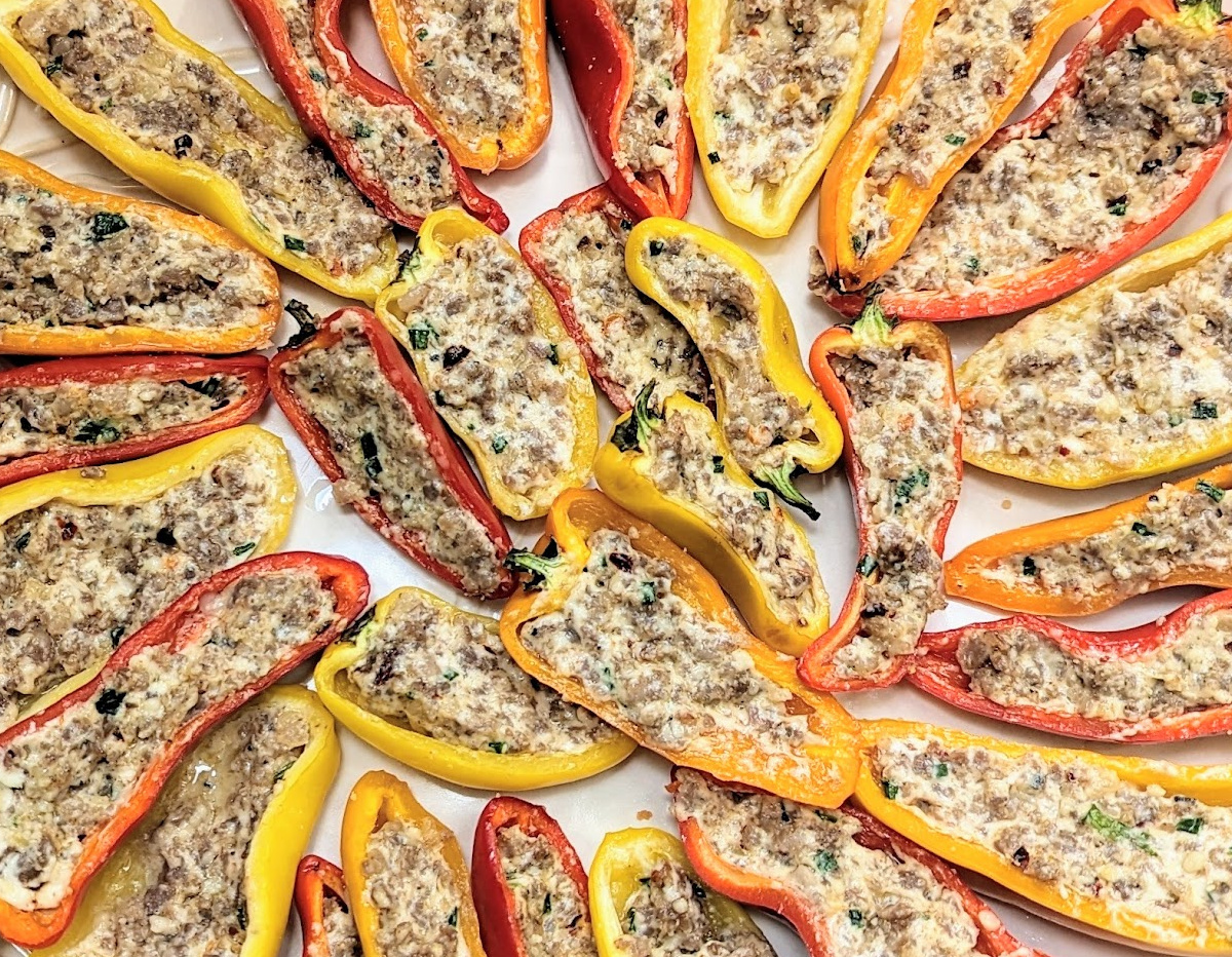 Sausage Stuffed Sweet Mini Peppers fanned out on a serving platter