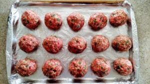 The Best Italian Meatballs on a sheet pan before they've baked.