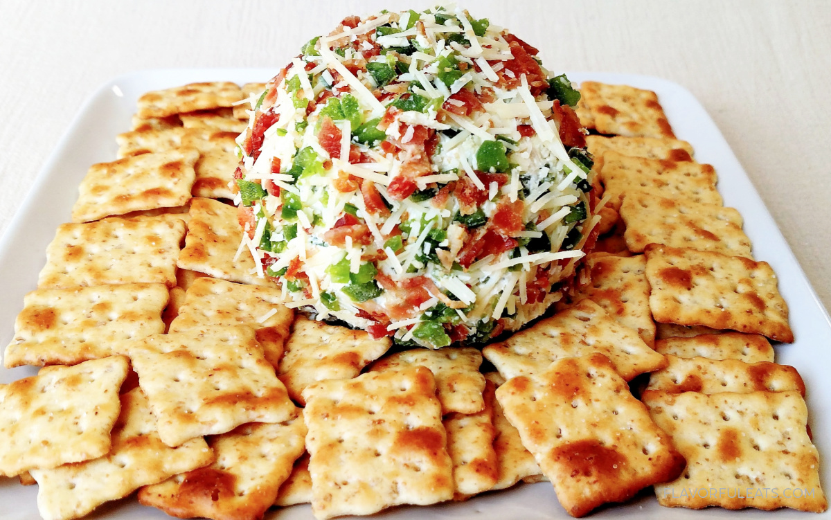 Jalapeno Bacon Swiss Cheese Ball on a white plate with crackers