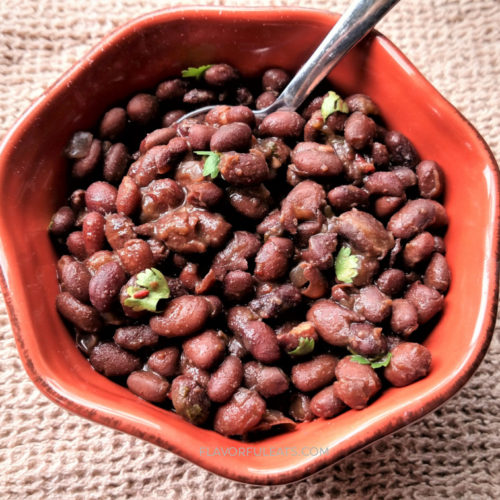 A clay bowl filled with Smoky Slow Cooker Mexican Black Beans