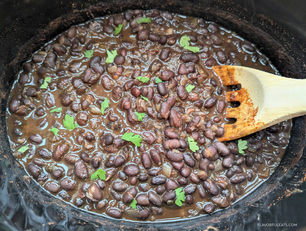 Smoky Slow Cooker Mexican Black Beans in a slow cooker garnished with cilantro.