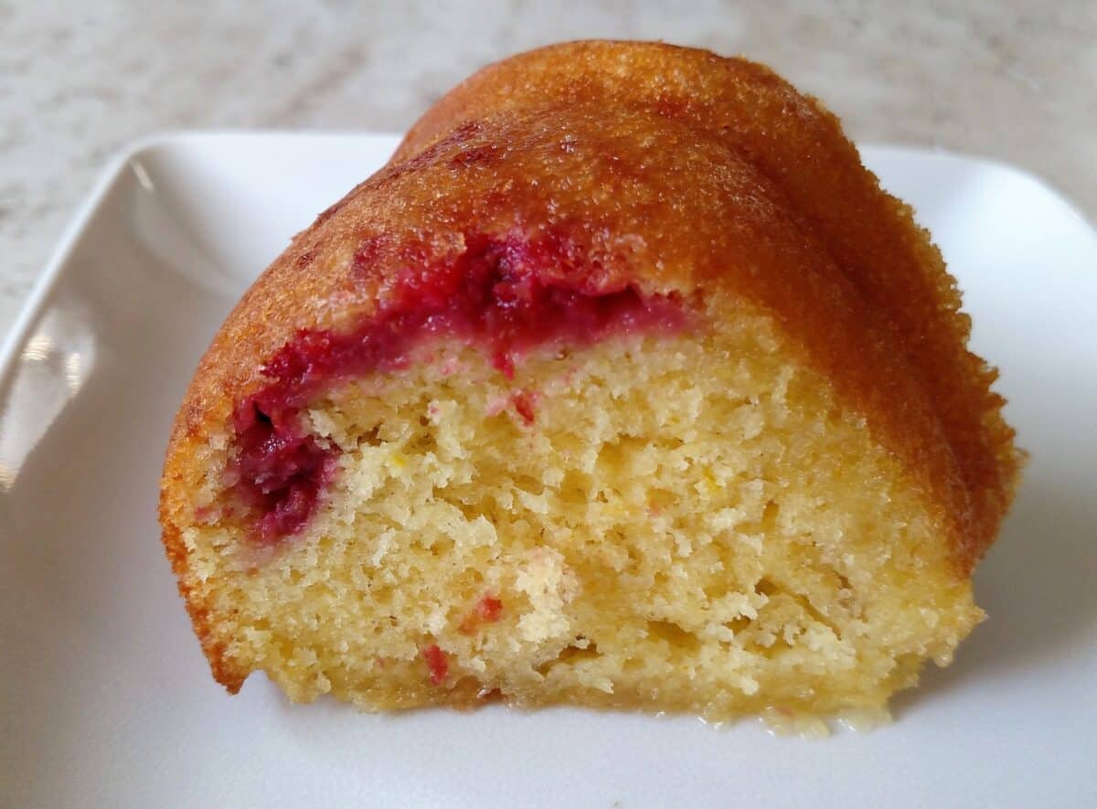 A slice of Lemon Raspberry Bundt Cake on a plate.