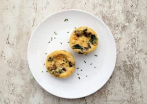 Two Spinach & Mushroom Muffin Pan Omelets on a white plate with chives