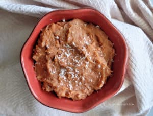 A bowl of Slow Cooker Refried Beans ready to be served.