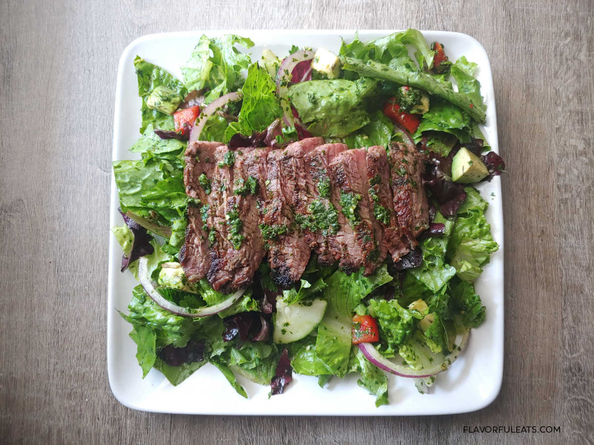 Chimichurri Steak Salad on a white plate.