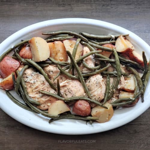 A white platter filled with Slow Cooker Lemon Garlic Chicken & Veggies.