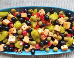 Marinated Cheese & Olive Antipasto on a blue platter
