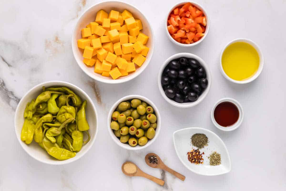 A photo of the ingredients needed to make Marinated Cheese & Olive Antipasto.