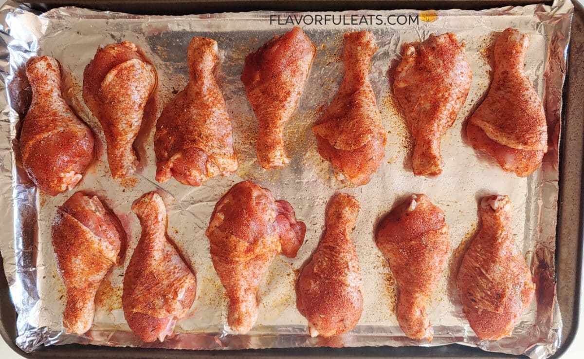 Spicy Baked Chicken Drumsticks on a sheet pan before they've baked.