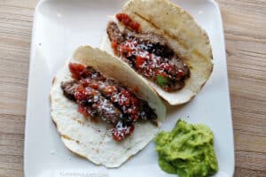 Carne asada tacos with guacamole on a plate