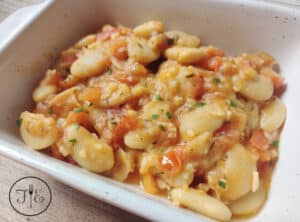 Sautéed White Beans with Tomatoes & Garlic up close at an angle.