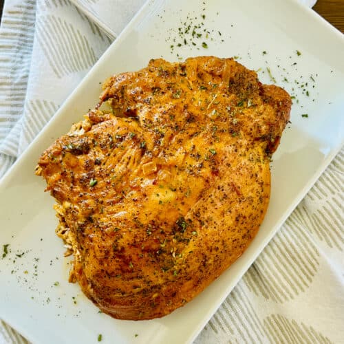 Slow Cooker Cajun Butter Turkey Breast on a platter for serving.