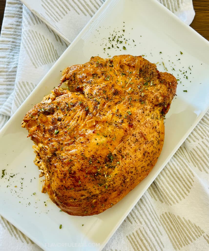 Slow Cooker Cajun Butter Turkey Breast on a platter for serving.