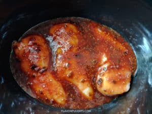 Chicken in the slow cooker covered in teriyaki sauce