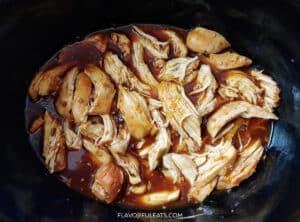 Slow Cooker Teriyaki Chicken & Broccoli with the chicken shredded before the broccoli is added.