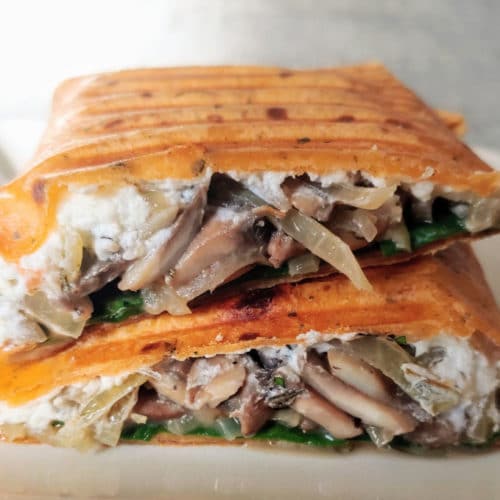 A Mushroom Goat Cheese Wrap cut in half to show the inside.