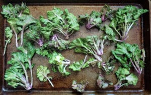 Kalettes (kale sprouts) on a baking sheet before they are baked
