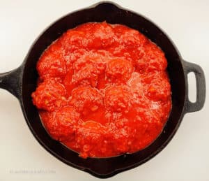 Cooked meatballs covered in marinara sauce