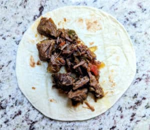 A tortilla filled with the Mexican Steak
