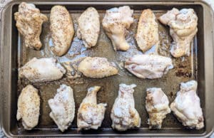 Chicken wings from the slow cooker added to a baking sheet