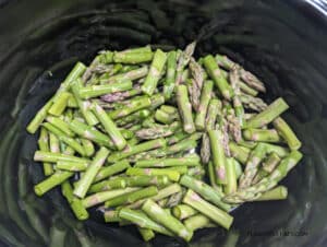 Cut asparagus in slow cooker