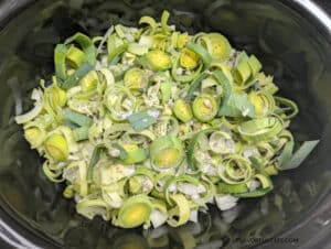 The vegetables needed to make Slow Cooker Asparagus Leek Soup in the slow cooker before it's cooked