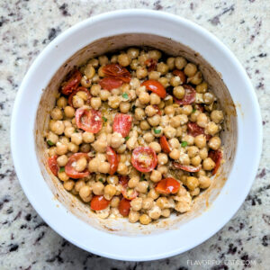 Baked Chickpeas with Tomatoes and Feta in a white bowl