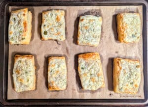 Dill Pickle Puff Pastry Appetizers on a baking sheet after they come out of the oven