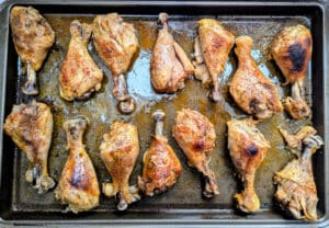 Slow Cooker Buffalo Chicken Drumsticks on a baking sheet after they were under the broiler
