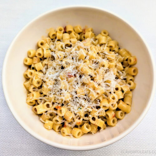 A white bowl filled with Calabrian Chili Butter Ditalini Pasta (One-Pan Recipe) with grated parmesan cheese on top