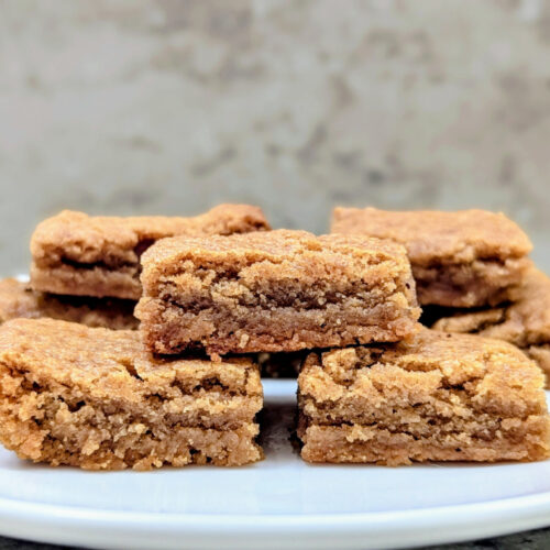 Slow Cooker Peanut Butter Cookie Bars stacked on a white plate