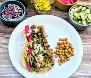 Sheet Pan Za'atar Chicken & Chickpeas in a wrap with chickpeas beside it.