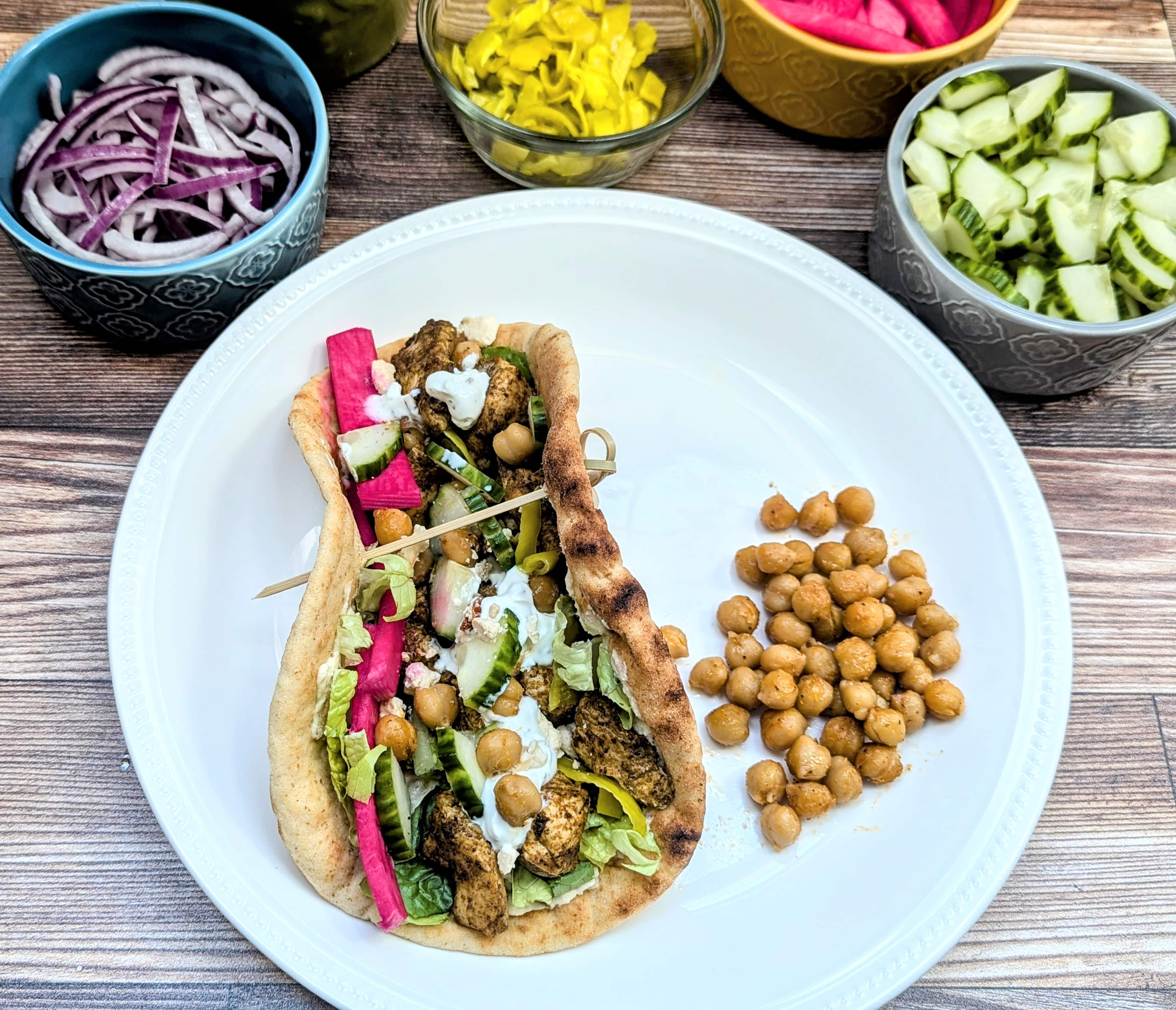 Sheet Pan Za'atar Chicken & Chickpeas in a wrap with chickpeas beside it.