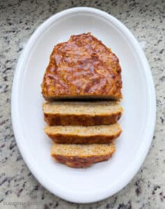 Slow Cooker BBQ Cheddar Turkey Meatloaf on a white platter cut into slices