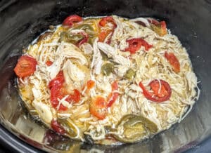 The cooked chicken mixture in the slow cooker, ready to make Slow Cooker Spicy Italian Chicken Sandwiches.