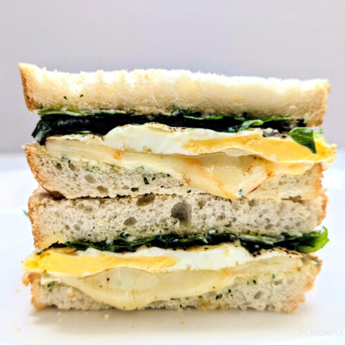 Fried Egg Sandwich with Herby Mayo cut in half and stacked on top of each other.