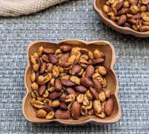 A bowl of Ghost Pepper Roasted Nuts with another bowl of them in the background.