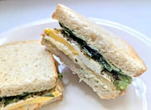 Fried Egg Sandwich with Herby Mayo cut in half on an angle.