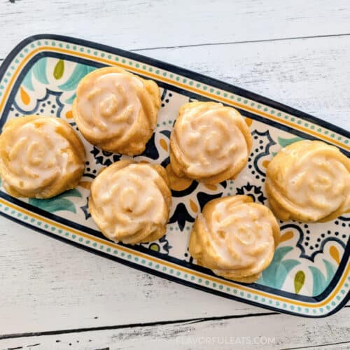 Mini Lemon Rose Bundt Cakes on a colorful serving platter.