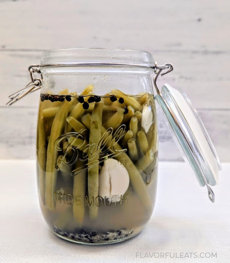 A canning jar filled with Horseradish Pickled Green Beans.