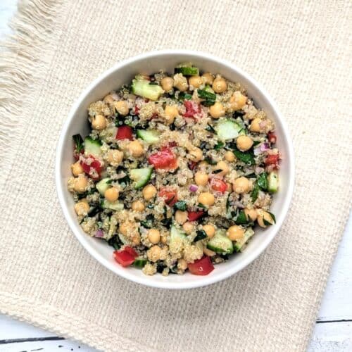 Lemony Quinoa Chickpea Salad in a white bowl on a placemat.