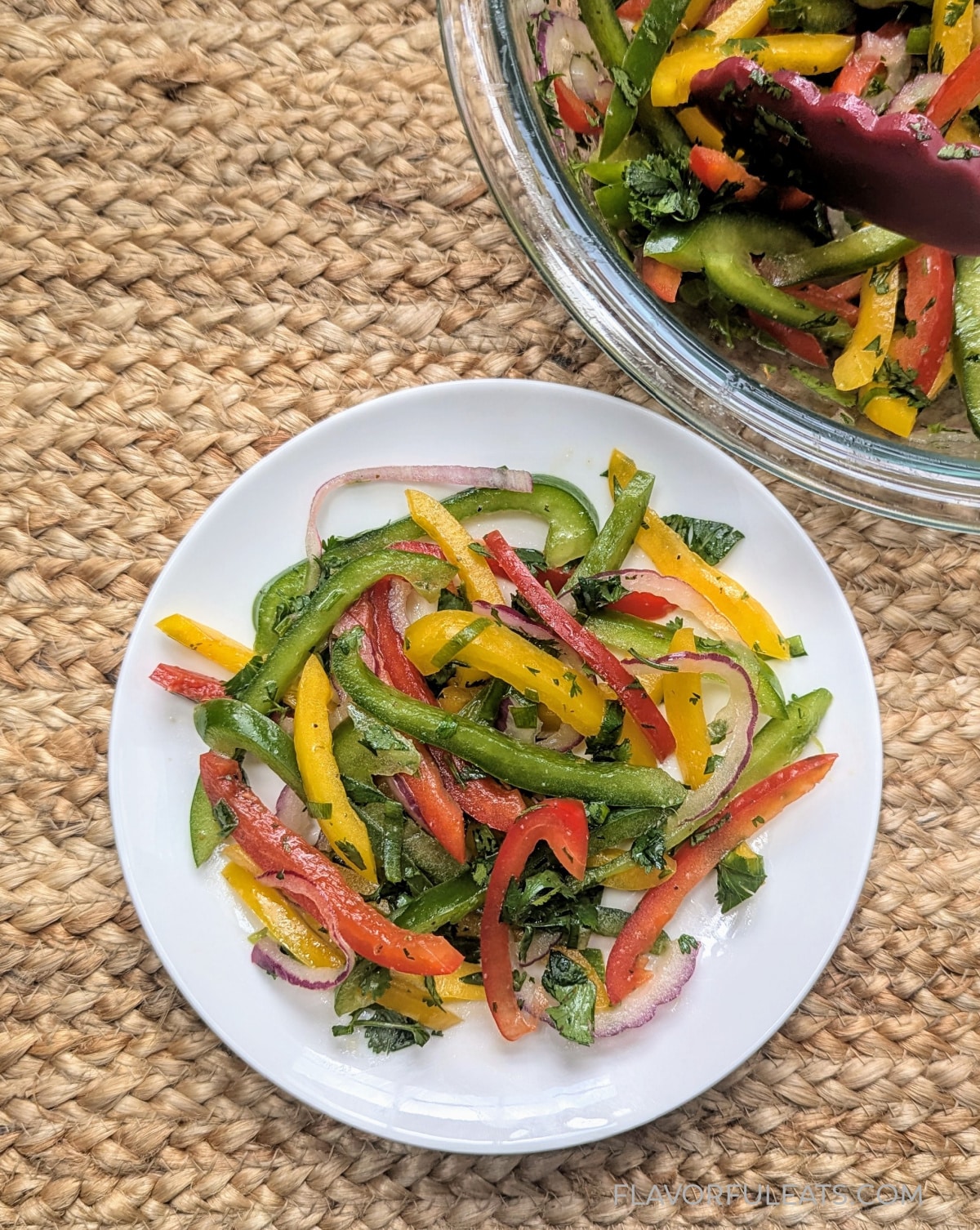 Cilantro Lime Bell Pepper Salad on a white plate with the bowl beside it.