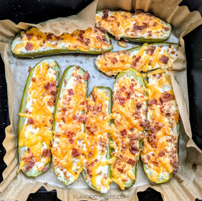 An air fryer basket filled with Air Fryer Chicken Bacon Ranch Stuffed Pickles after they've cooked.