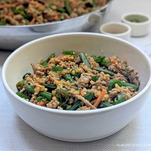 Gochujang Ground Turkey, Rice & Green Bean Skillet in a bowl with the pan in the background.