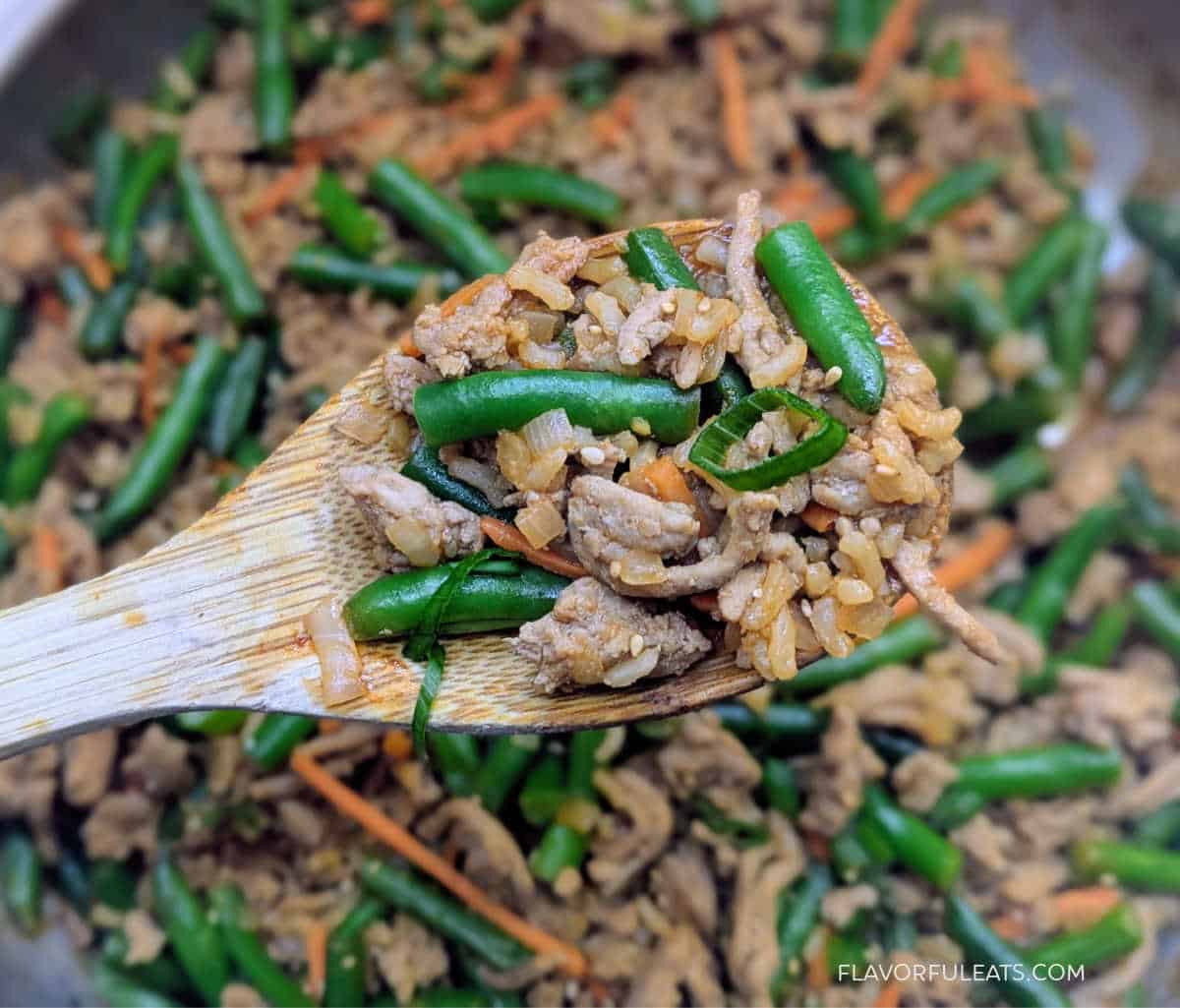 Gochujang Ground Turkey, Rice & Green Bean Skillet up close on a serving spoon.
