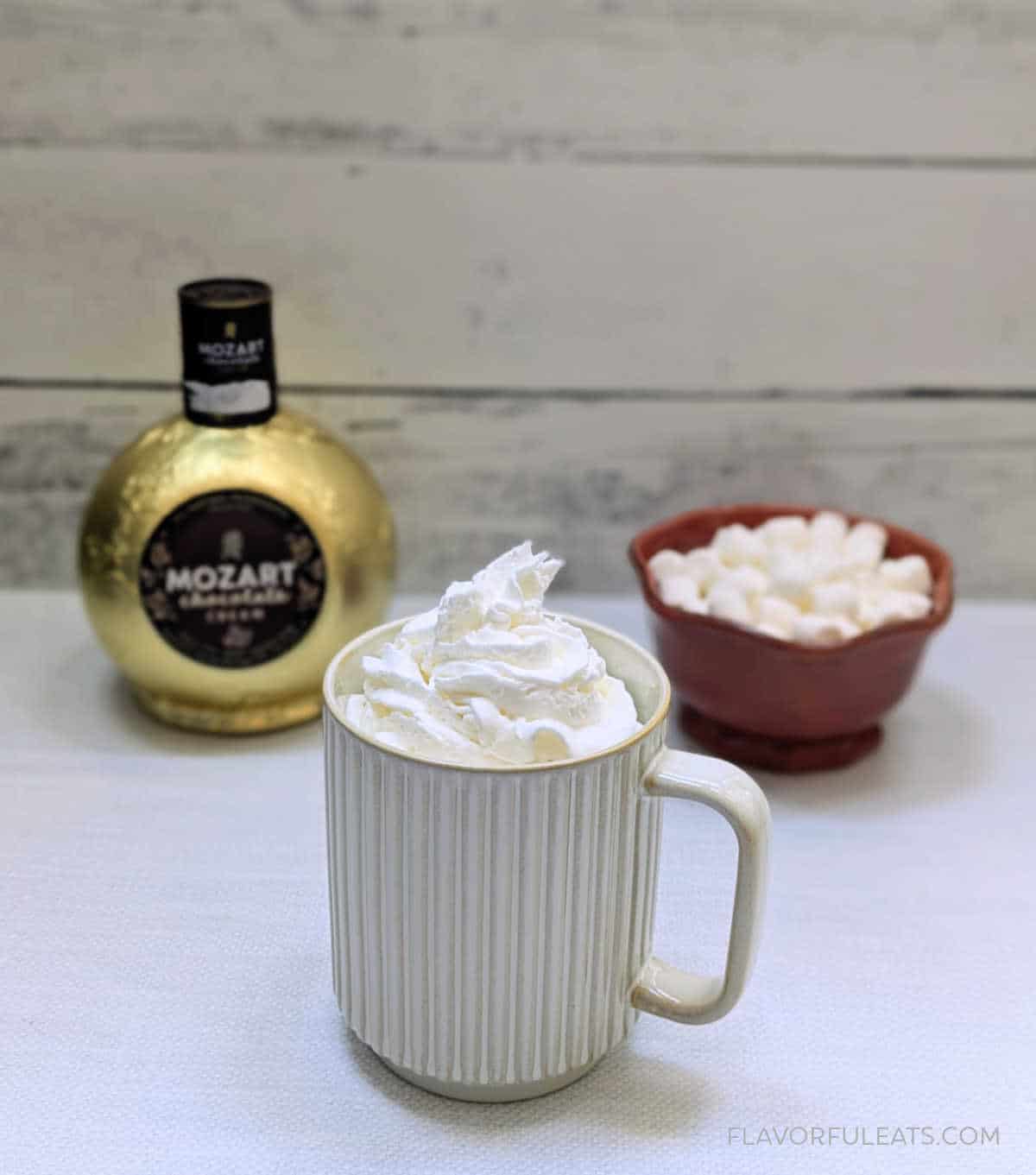 Slow Cooker Boozy Chocolate Coffee with Mozart Chocolate Liqueur and a bowl of marshmallows in the background.