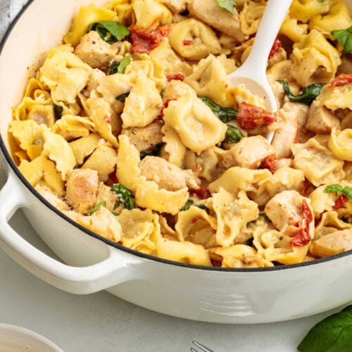 One-Pan Creamy Chicken & Tortellini in a pan with a serving spoon.