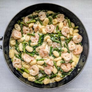 Creamy Shrimp & Gnocchi with Asparagus in a skillet.