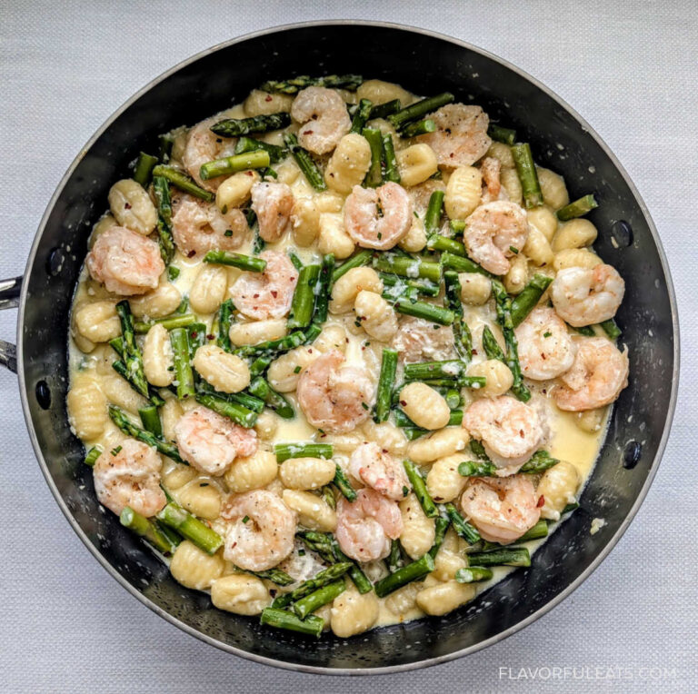 Creamy Shrimp & Gnocchi with Asparagus in a skillet.